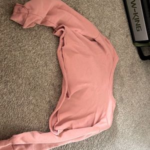 It is pink and it is really cropped and would be kinda short on kids